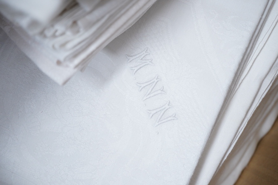 A collection of four sets of ten monogrammed French linen napkins and a similar set of twelve napkins, various odd sets of English Damask napkins, a large damask table cloth and a set of hand towels.